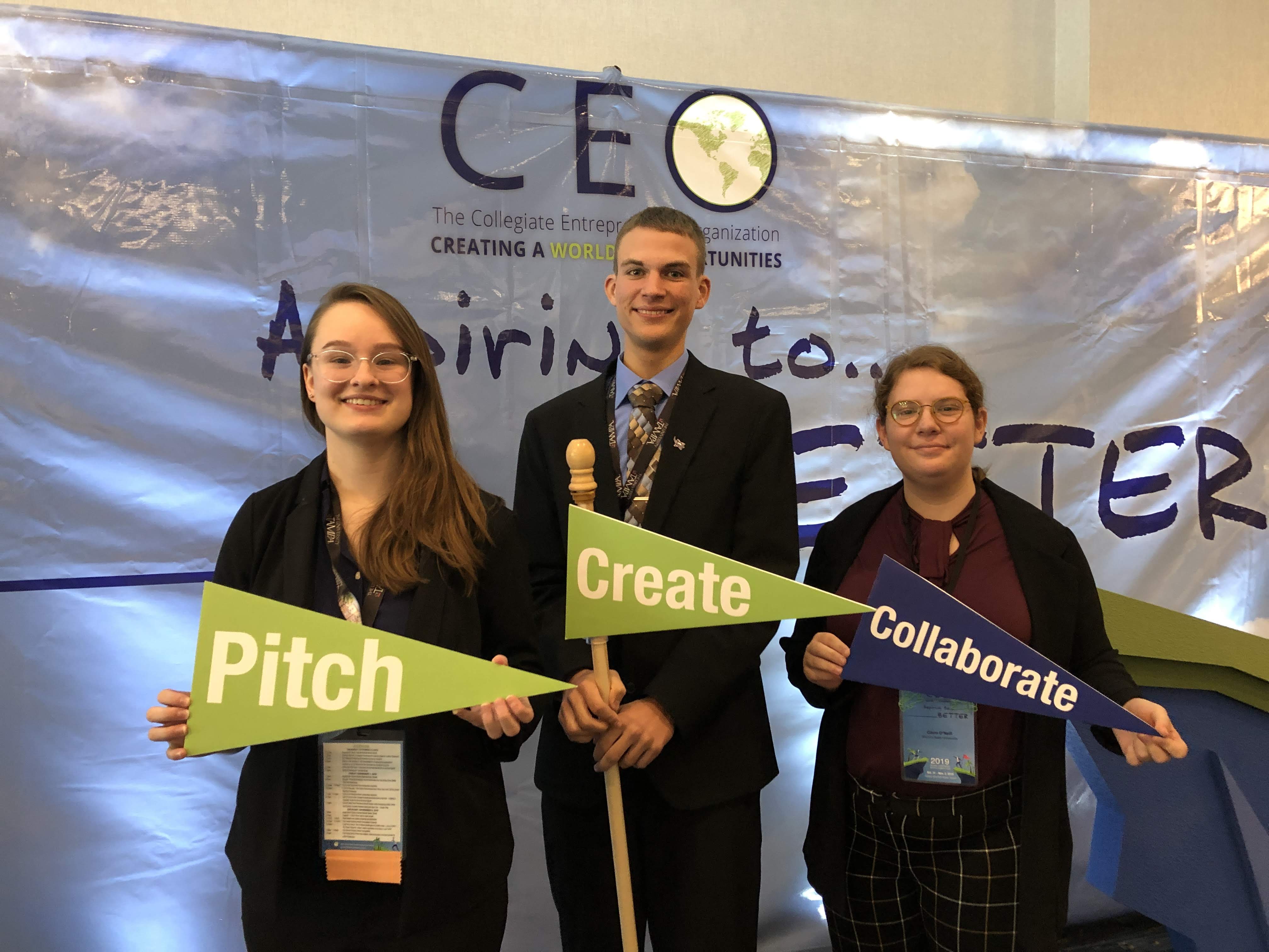Students holding banners that say Pitch, Create, Collaborate