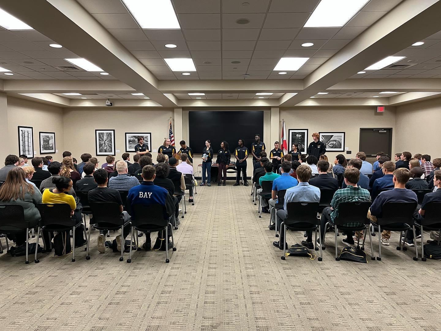 A group of CoESA members are paneling in a full room.