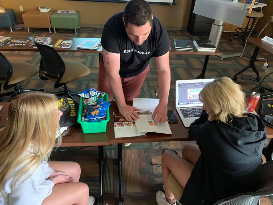 Students reviewing a brochure together in class