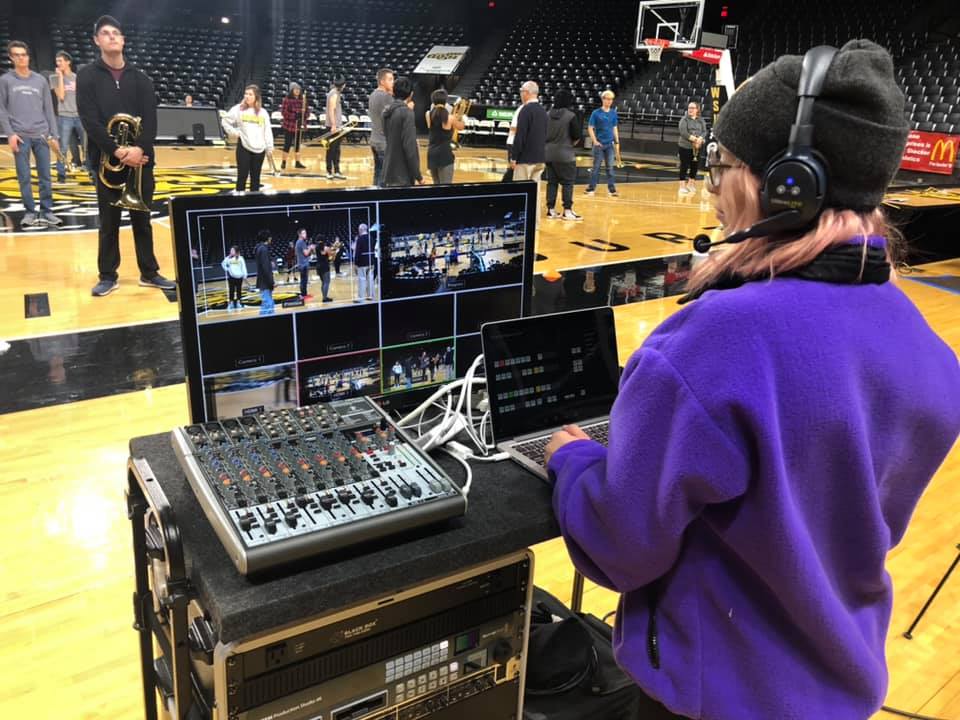 Student, Mya Acosta, running a multi-camera live switcher at Koch Arena during a Shocker Sound Machine rehearsal.