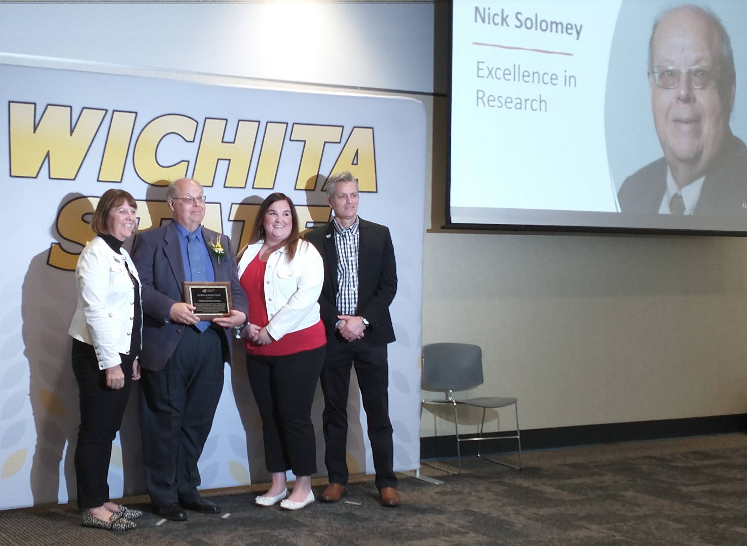 Prof. Solomey receives the University Excellence in Research award on May 6, 2022.
