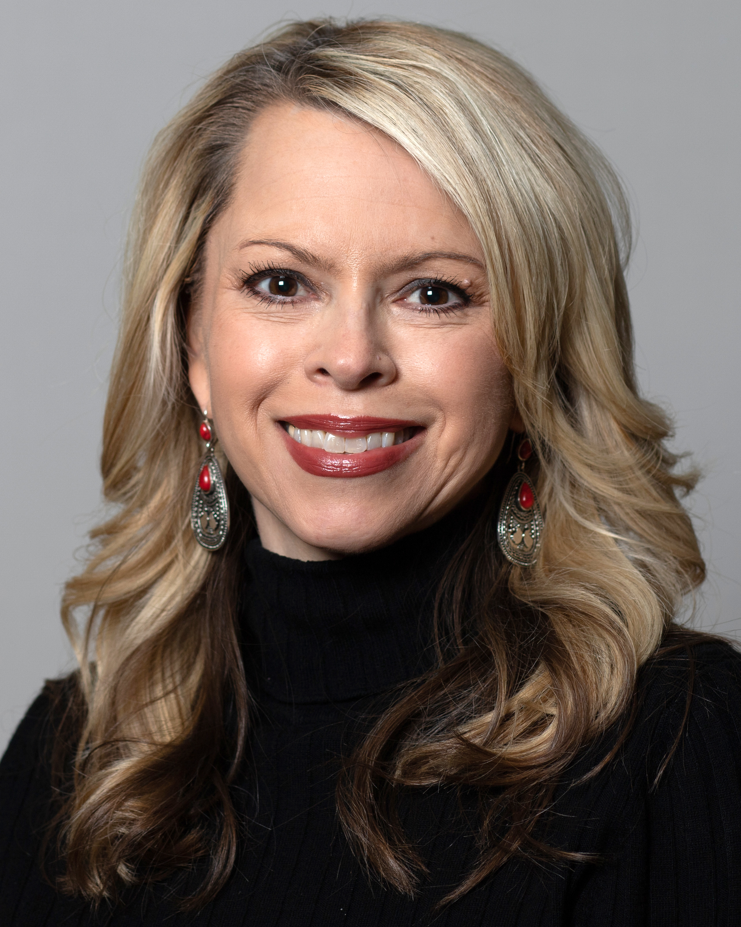 headshot of white woman smiling directly at camera