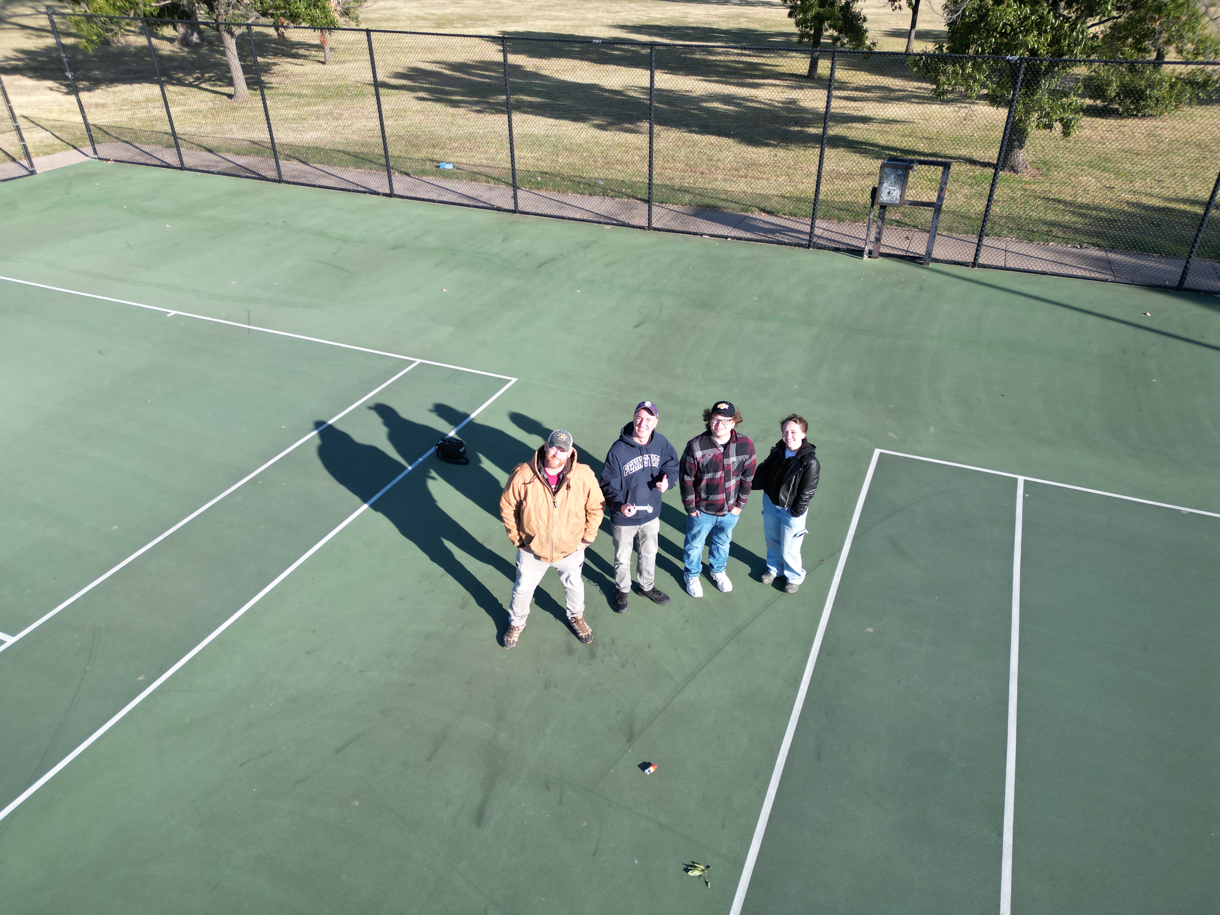 group of adults staring up to a UAV
