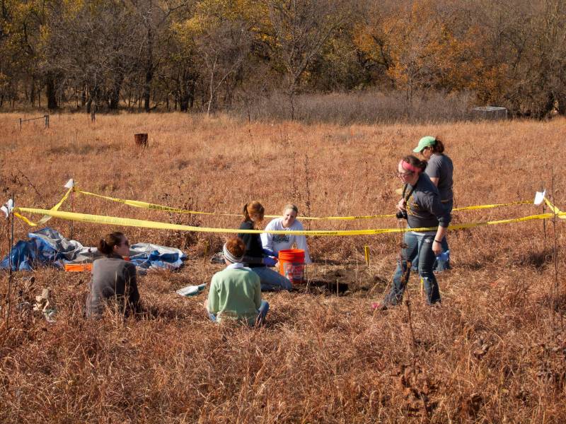 Students performing a mock excavation of a clandestine grave at Skeleton Acres Research Facility