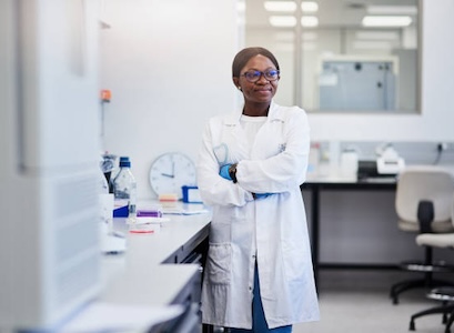 Lab manager standing cross armed in lab