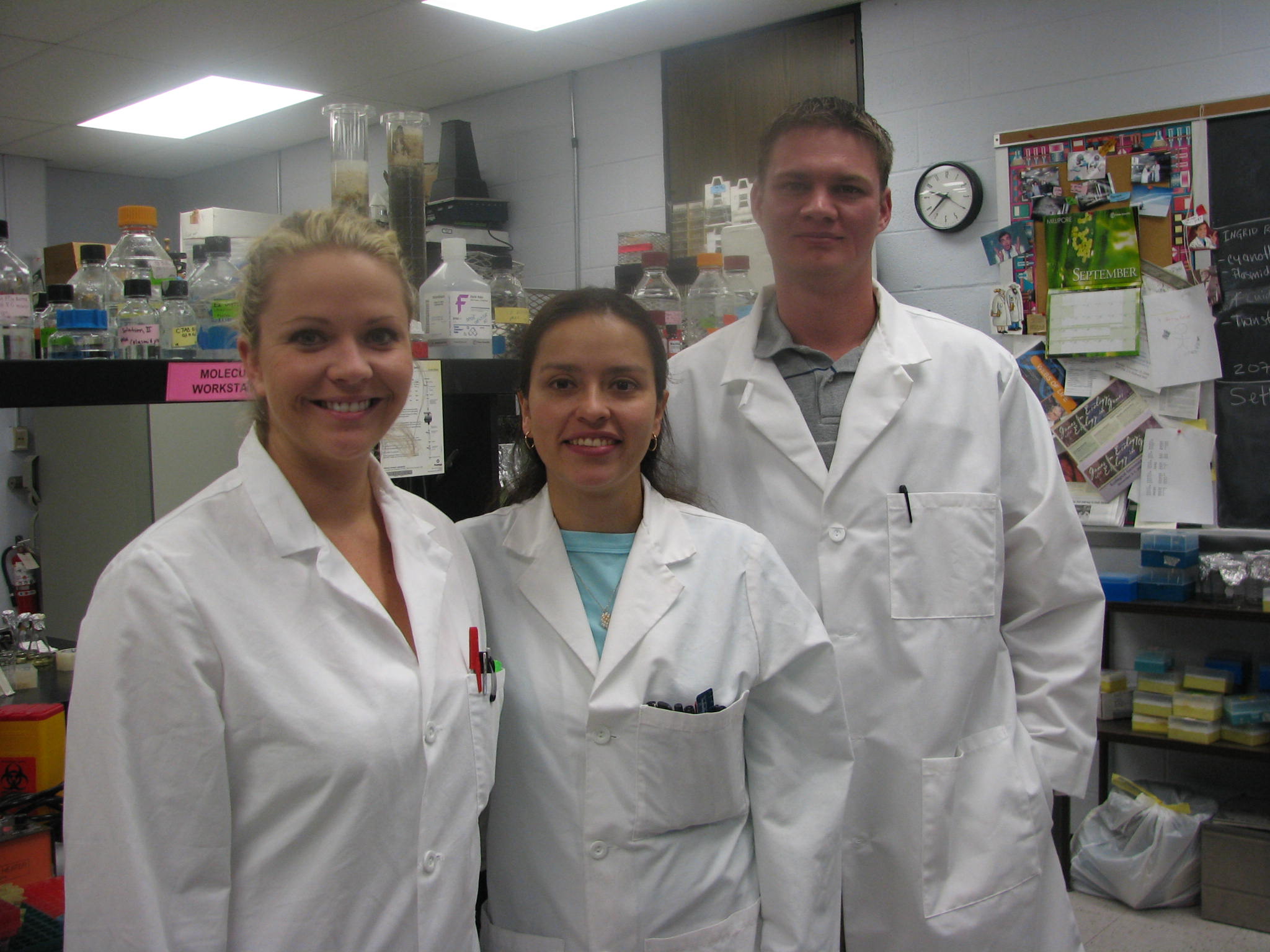 Three students in lab coats