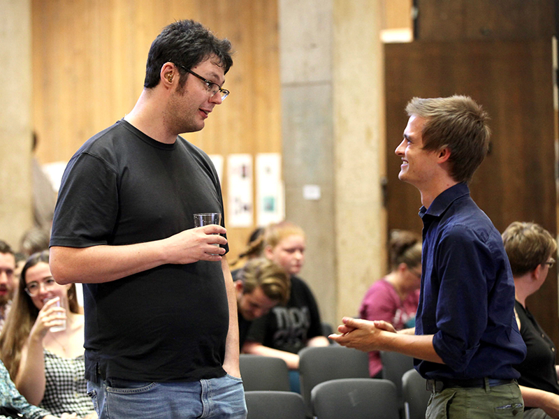 Creative writing students mingle at an event