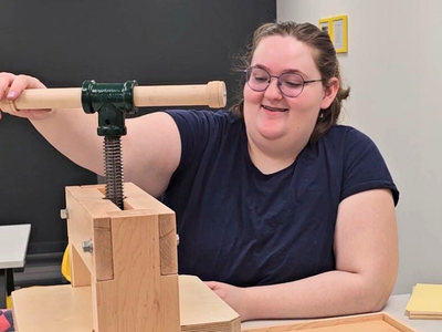 Lily operates the Book Beetle press