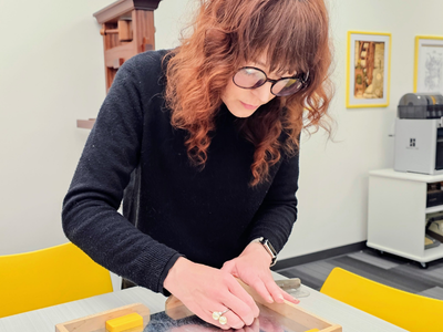 Liz adjusts magnetic furniture in a galley