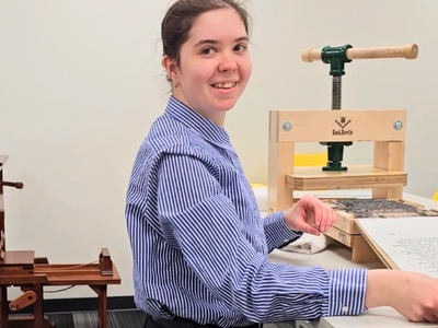 Claire pulling a print off the press
