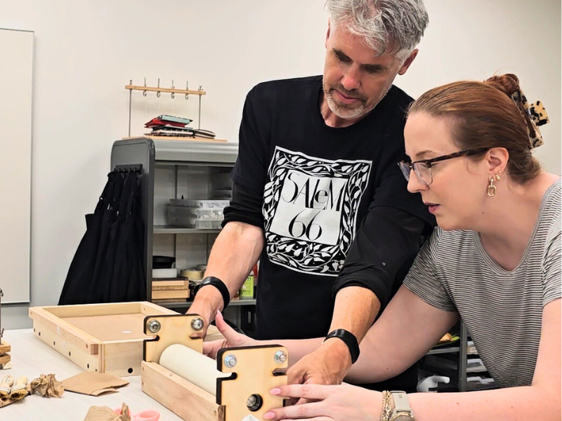 lab directors Fran Connor and Katie Lanning build a press