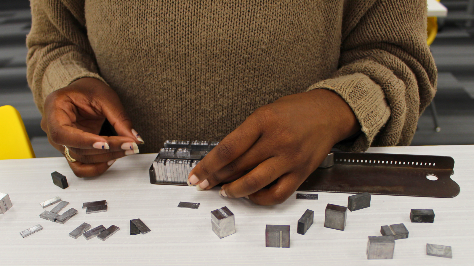 typesetting letters in a composing stick