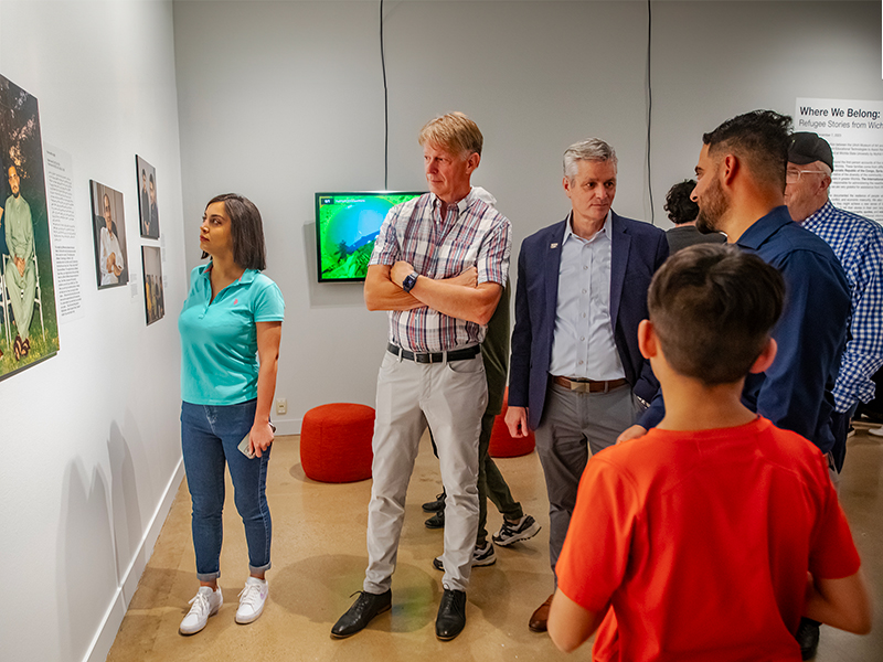 WSU President Muma and First Gentleman Rick Case chat with exhibit opening attendees