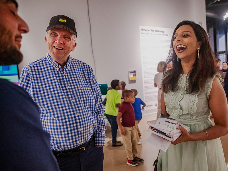 Dr. Menon talks with attendees of the Ulrich Fall Exhibition opening