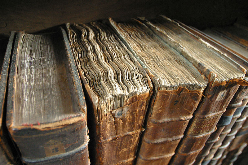 Close-up of worn pages on leather-bound books