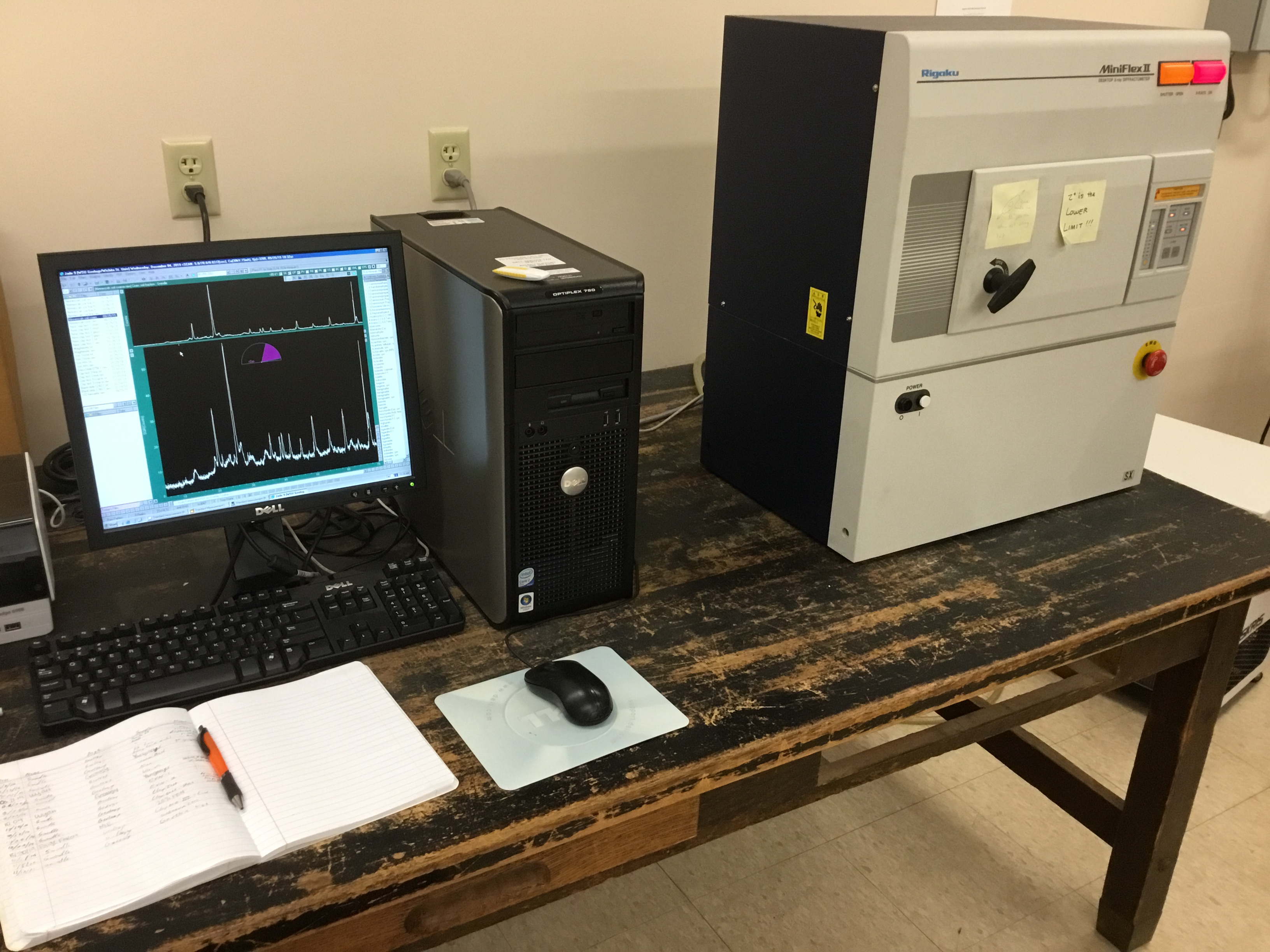 Geology measurement software is visible on a computer screen at a desk