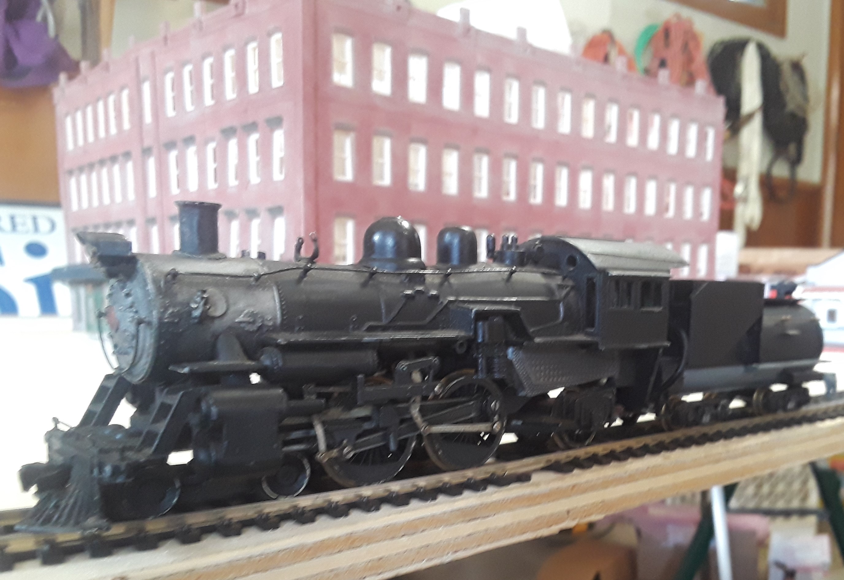 Model locomotive in front of model of the Eldridge Hotel