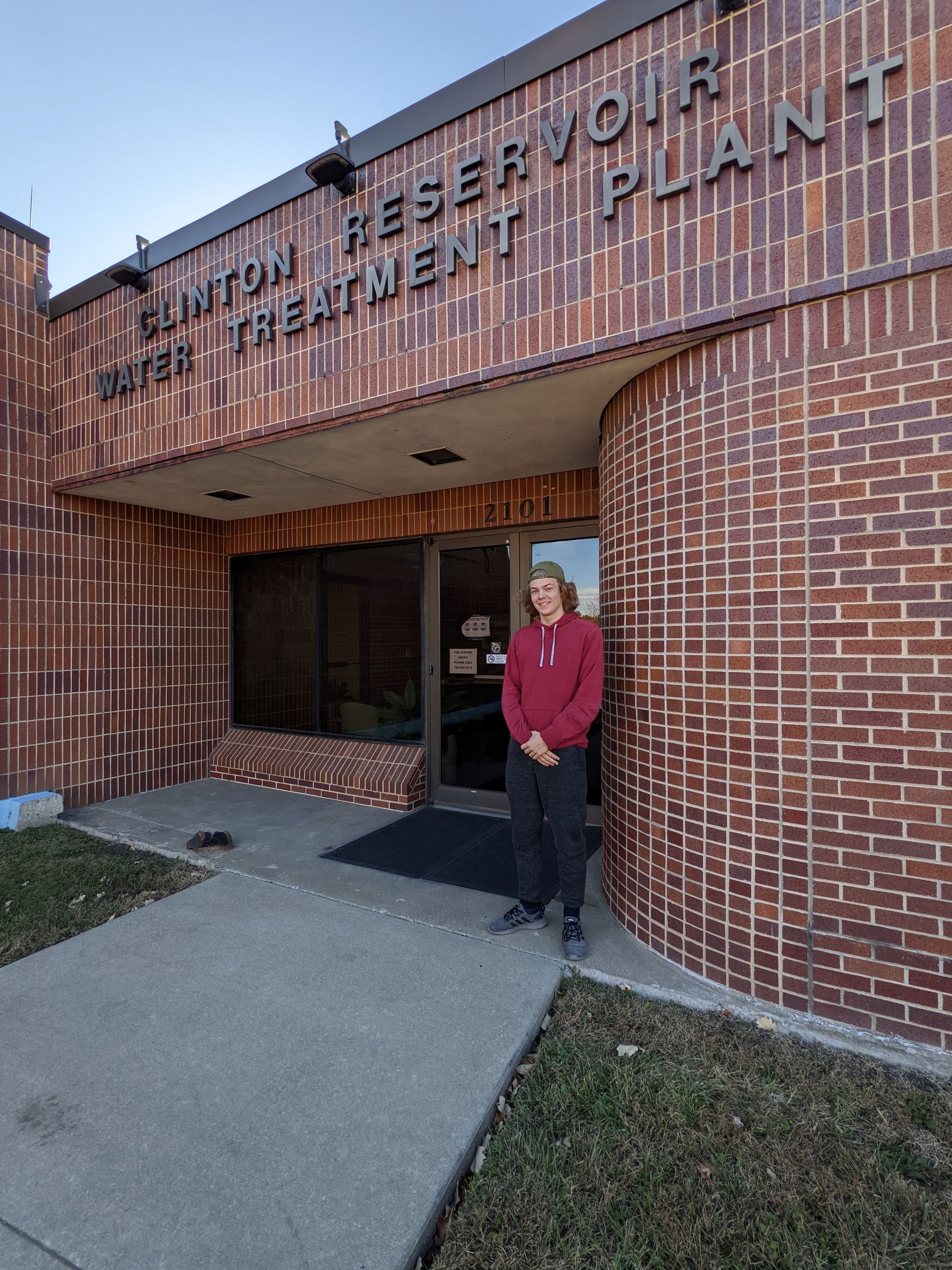 Adam Schnurr stands in front of treatment plant