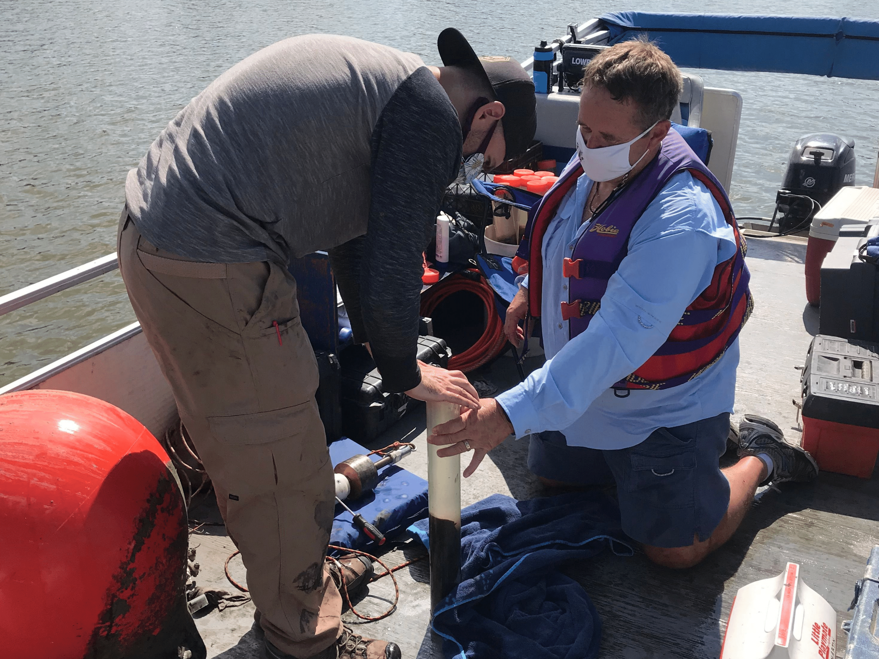 Dr. Brian Bohnsack (right) works with a team of researchers to collect blue-green algae samples from Marion Reservoir in Kansas.