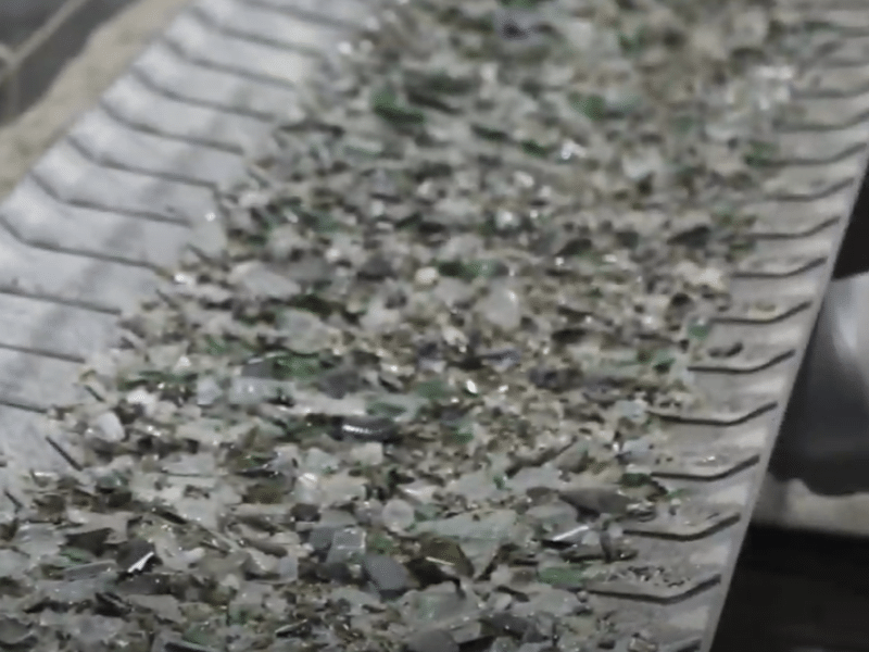 crushed glass on the factory line on the way to be recycled