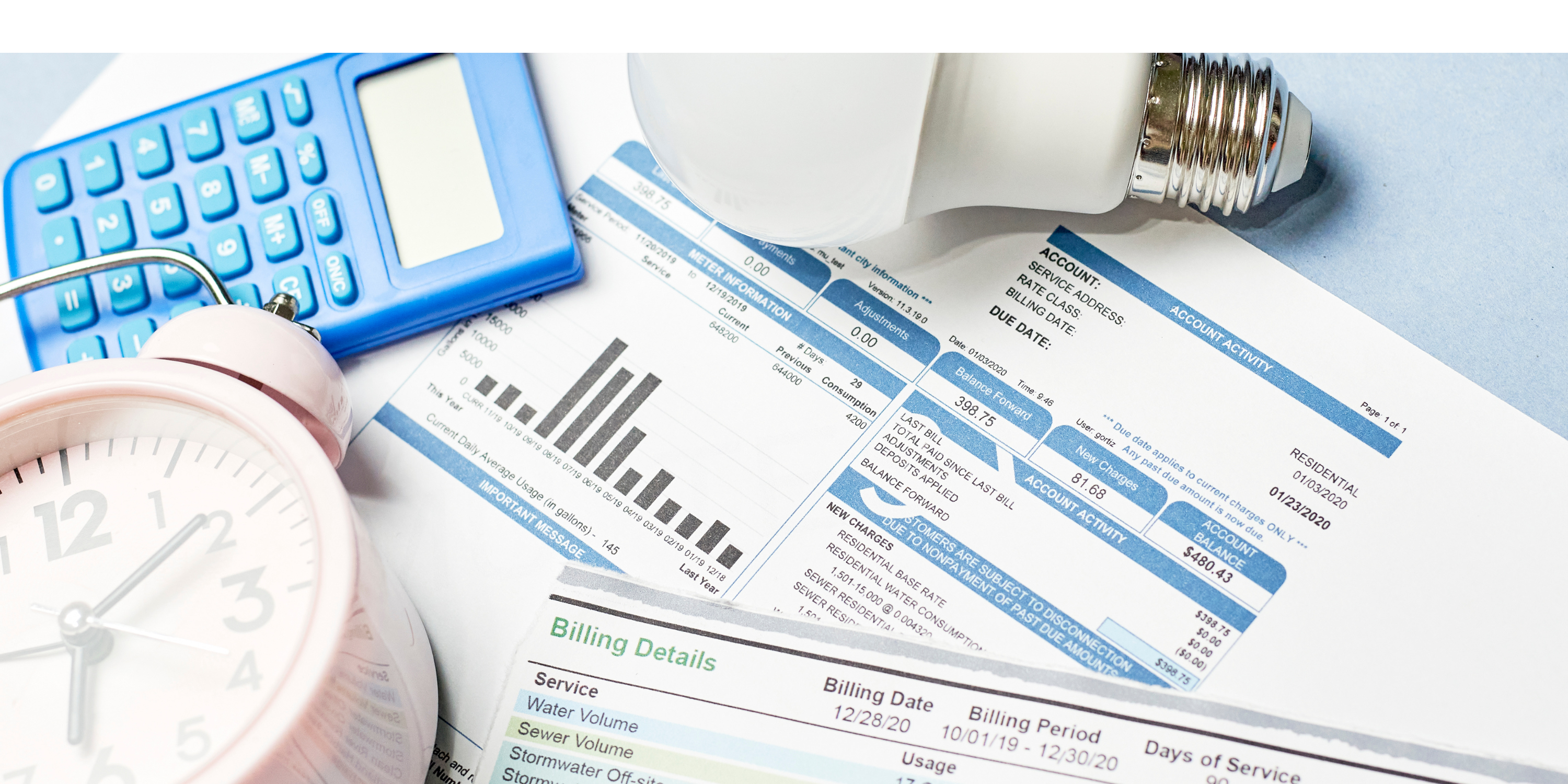 Image of a utility bill, light bulb, calculator, and alarm clock.