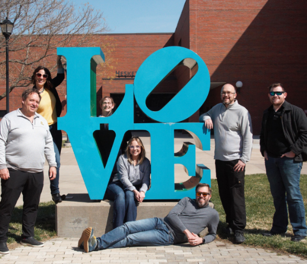 EFC Staff next to the Robert Indiana "LOVE" sculpture at Wichita State University. People in order from left to right are Analisa Munhall, Brian Bohnsack, Tonya Bronleewe, Michelle DeHaven, Baylee Vieyra, Jeff Severin, Nick Willis, and John Colclazier