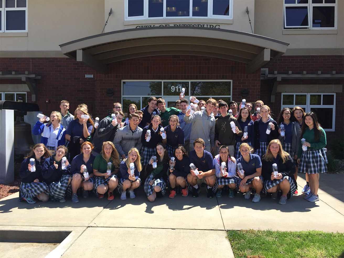 Photo of high school students in front of a school