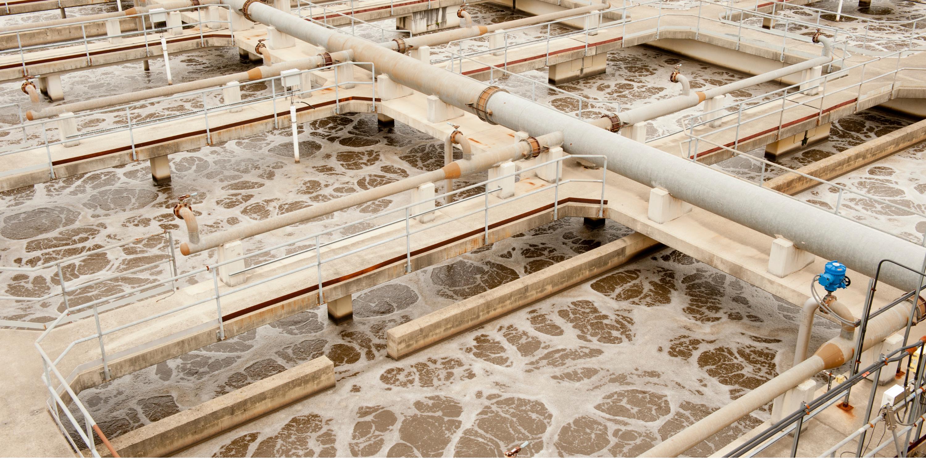 a large wastewater treatment aeration tank with many pipes