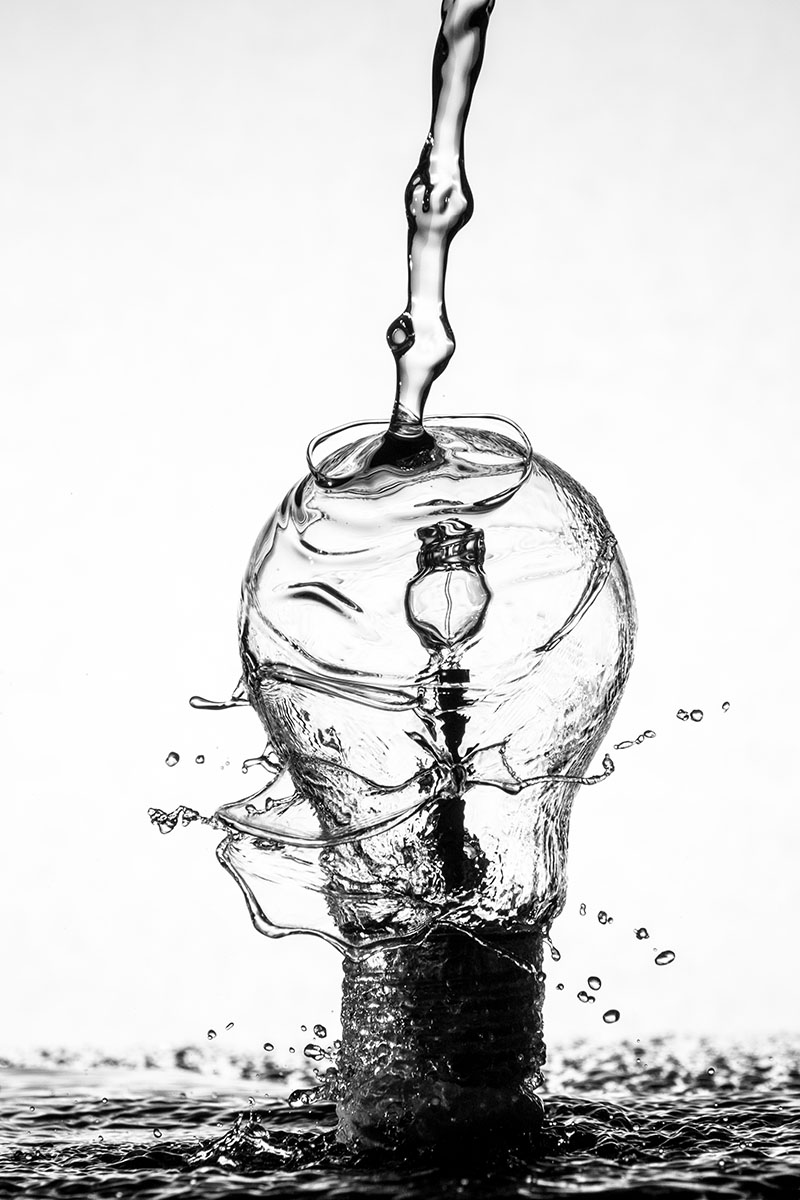 decorative image of lightbulb made of pouring water