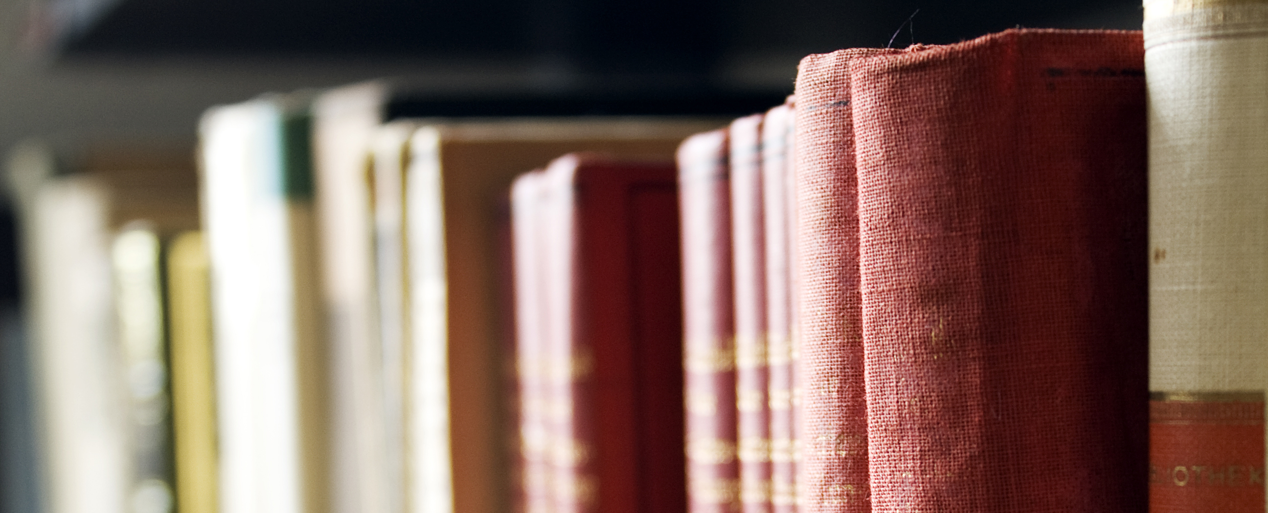 Close up photo of books on a bookshelf. 