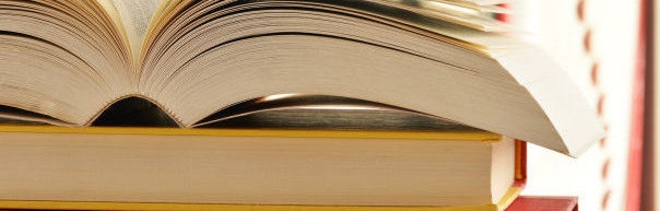 Image of an open book sitting on a table. 