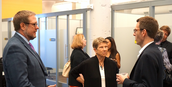 attendees talk at a conference