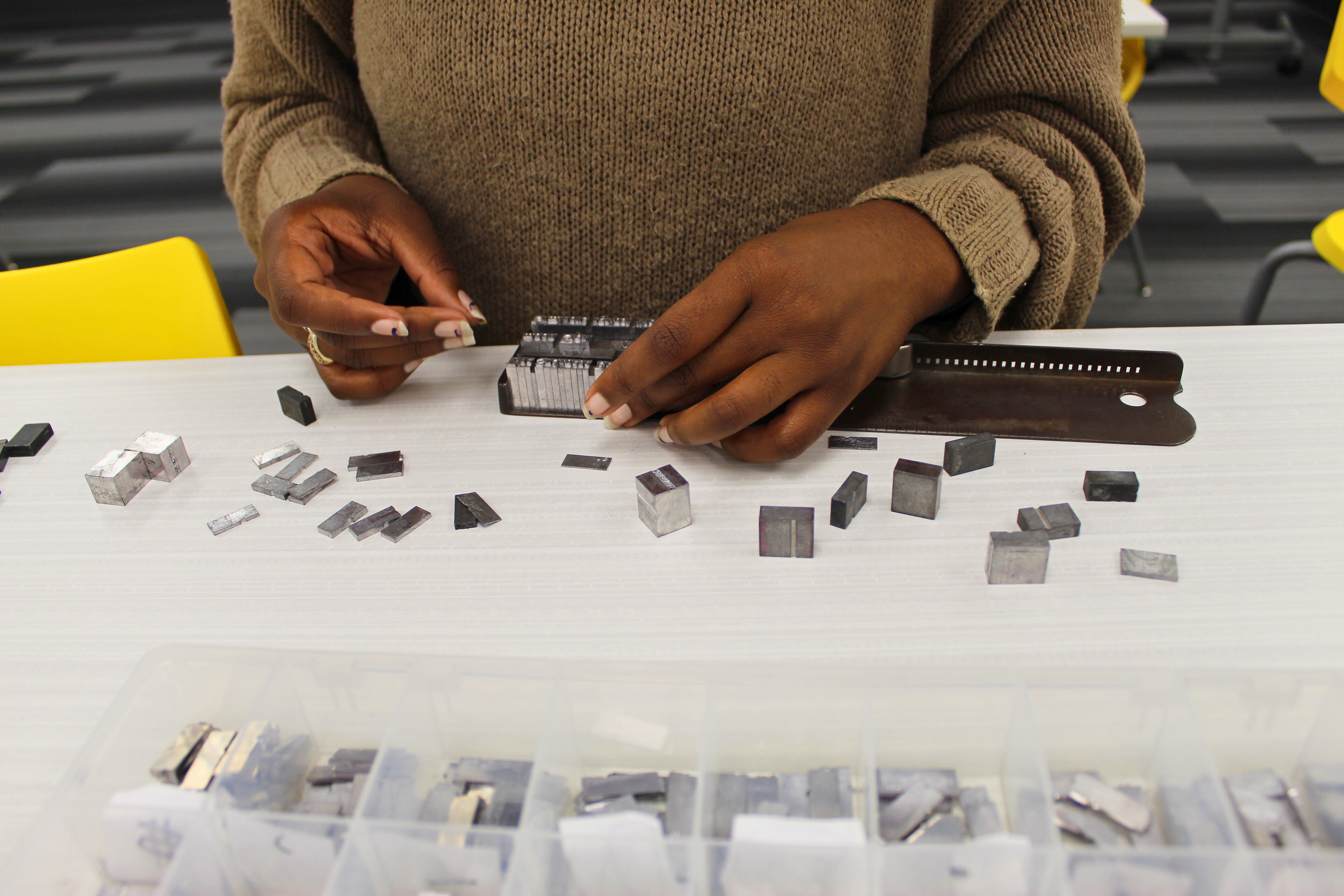 Student fingers setting type