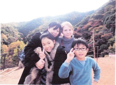 Students posing with members of a Japanese family. 