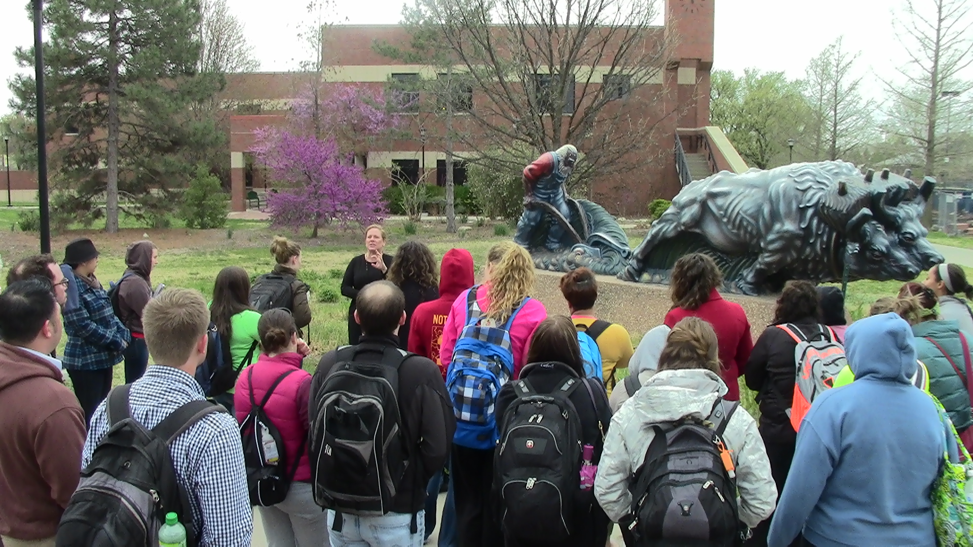 Photo of Sigma Delti Pi members attending an outdoor lecture. 
