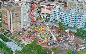 Photo of one tower standing, one tower collapsed