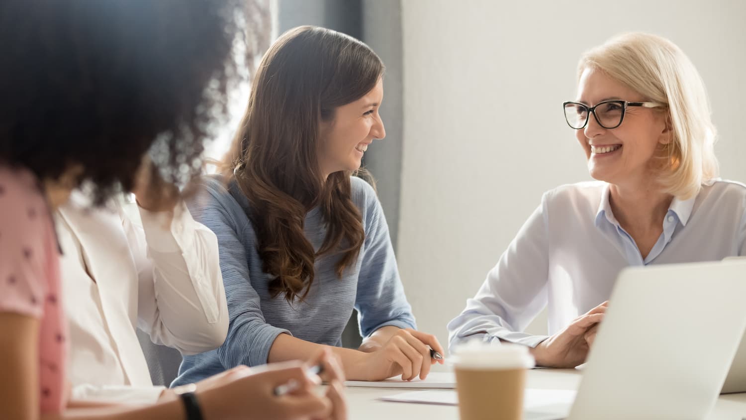 two women talking at a desk