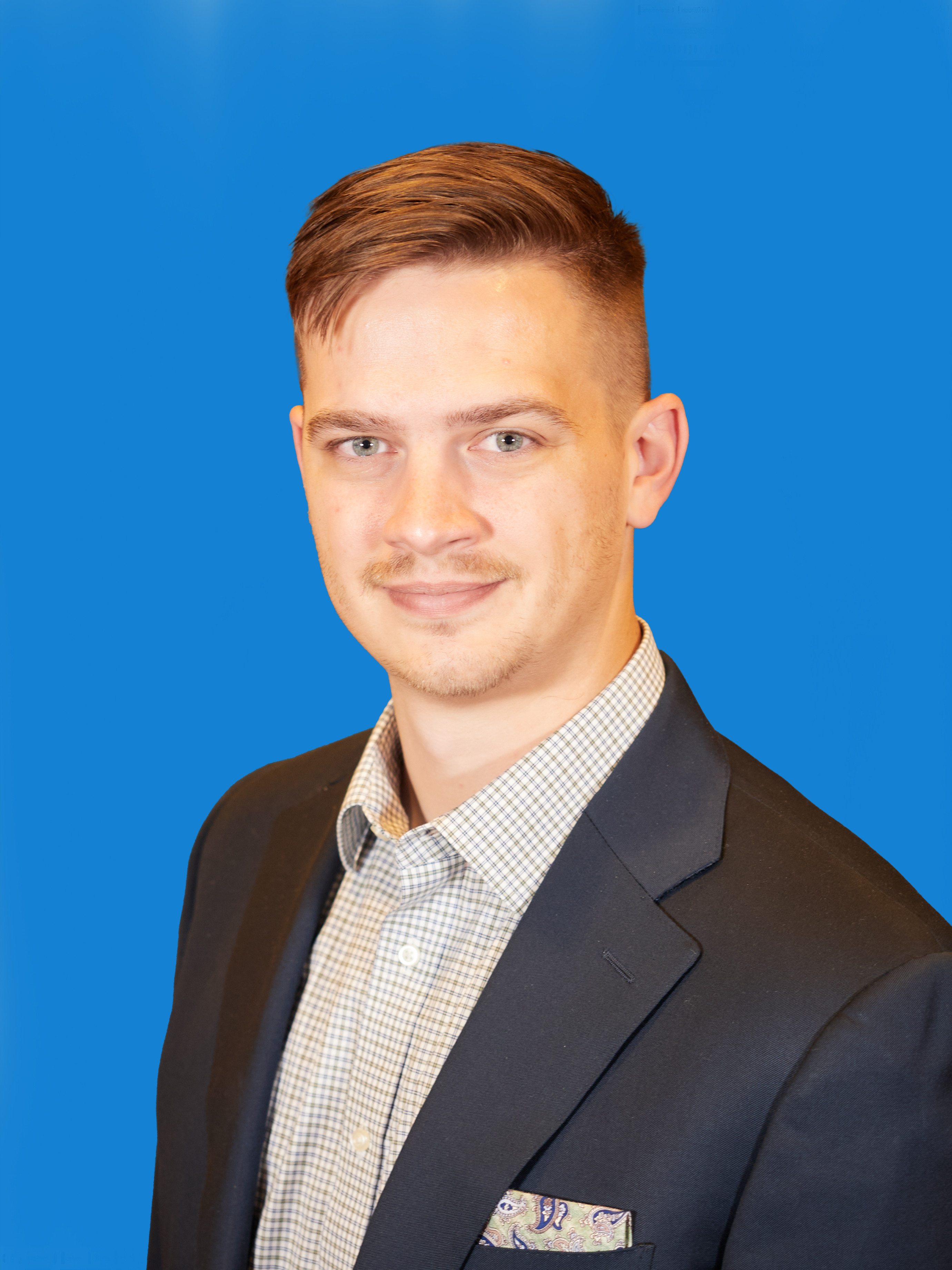 head shot of man in suit coat