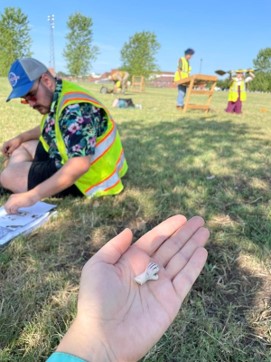hand holding small artifact