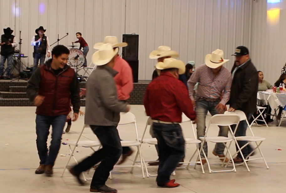 group of men walking around chairs
