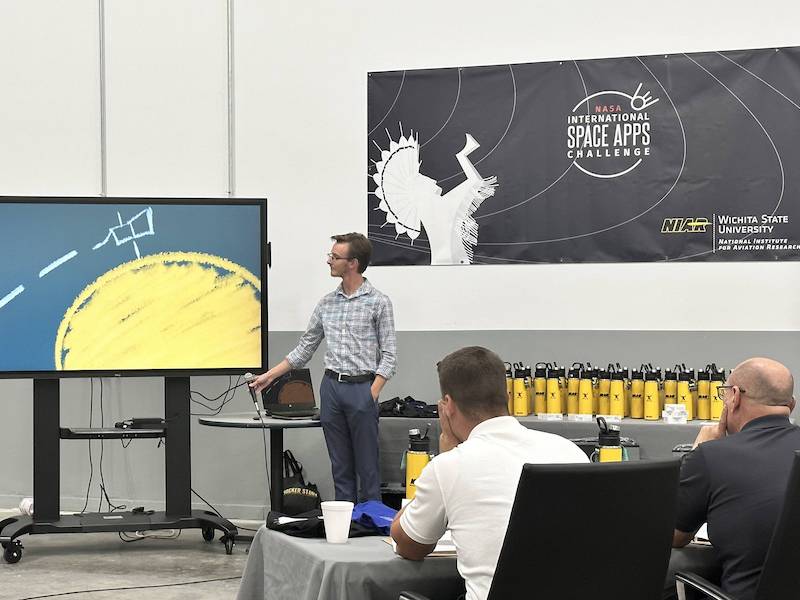 Photo of Jacob Workentine pitching his ideas to a panel of judges.