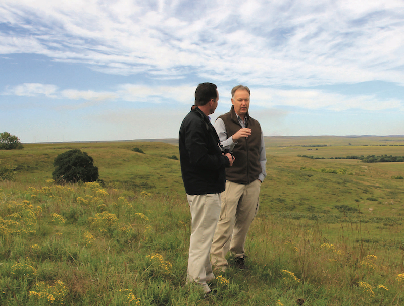 Photo: Andrew Hippisley listens as Greg Houseman, associate professor of biological sciences, describes research opportunities at Youngmeyer Ranch. 