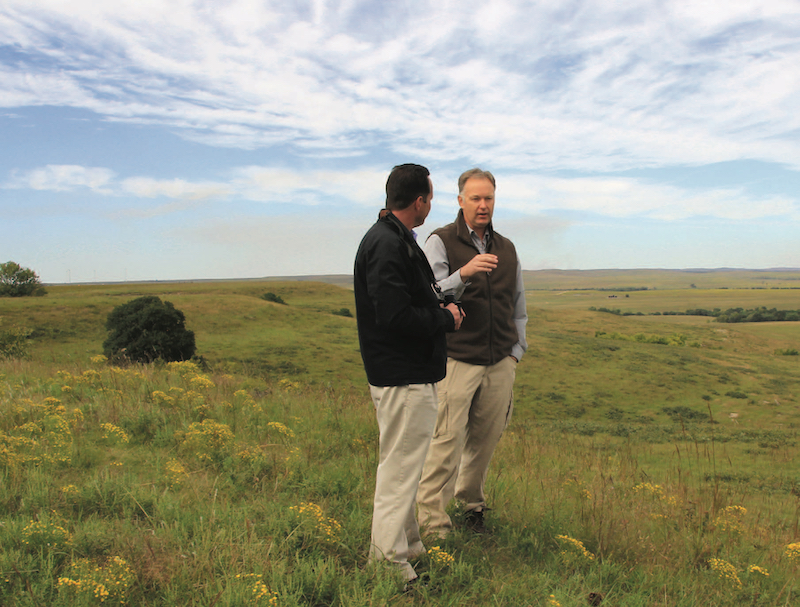 Photo: Andrew Hippisley listens as Greg Houseman, associate professor of biological sciences, describes research opportunities at Youngmeyer Ranch.