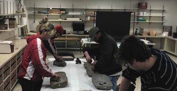 Photo: Students in Dozier’s Anth 397 class, Anthropology of Food and Nutrition, grind food using artifacts with unknown provenance. Dozier studies foodways and cooking technologies, which are the habits and practices of people as it relates to eating, food creation and preparation. Not only does she admit to loving food, but she learns a lot about the people who prepare it.