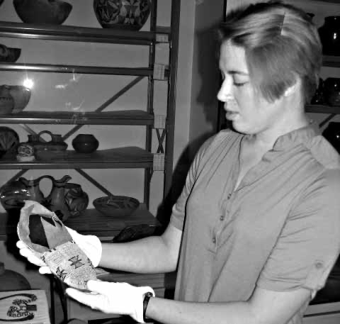 Jordan Adams holds a Moccasin in need of reshaping and some light cleaning. 