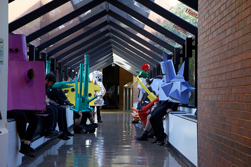 Students in costume lined up in Mcknight's second floor crosswalk.