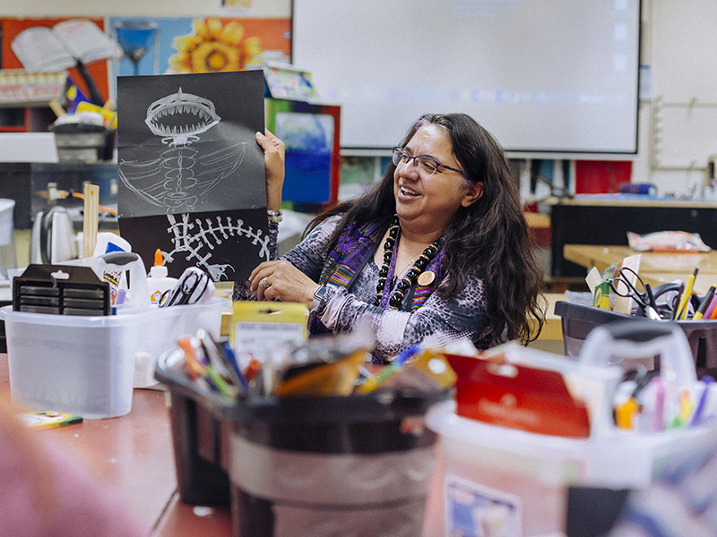 Lori Santos holding up a craft.