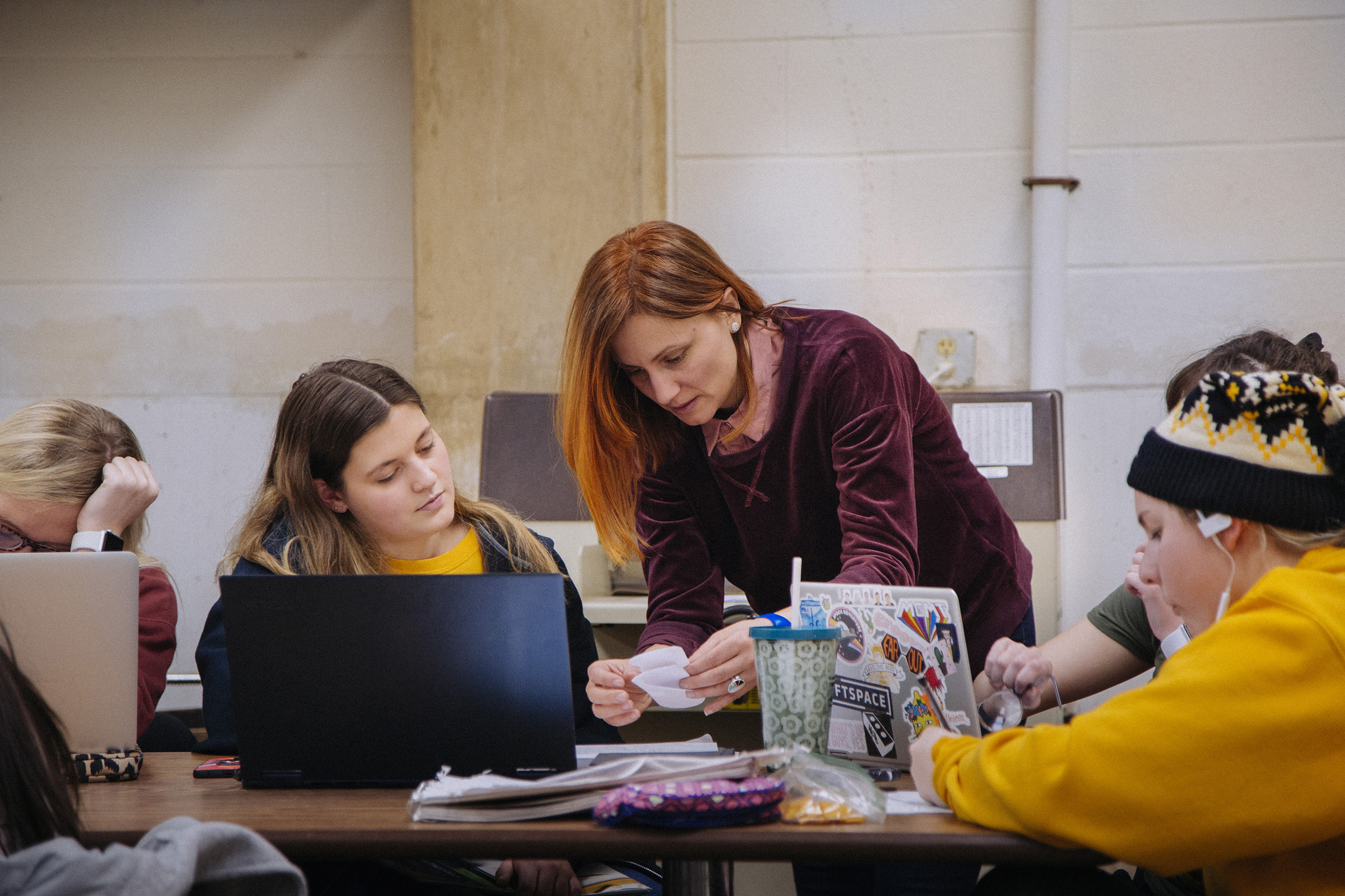 Three students work on a project in one of ADCI's expansive print media studios.