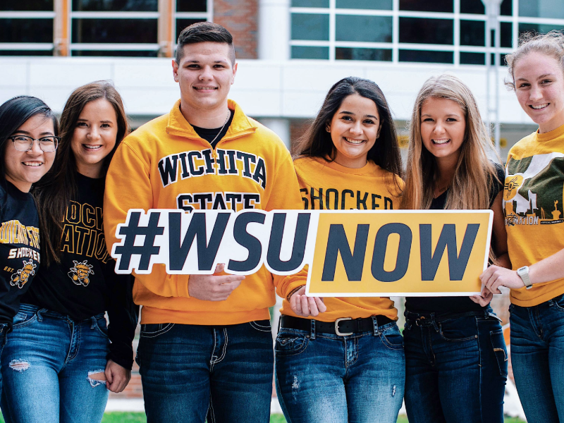 Students holding WSU signs.