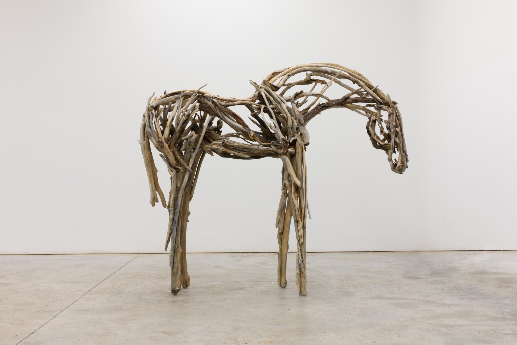 A picture of Deborah Butterfield's Lumen scuplture. It is a scuplture in the shape of a horse, constructed from branches and sticks to develop the sculpture's form.